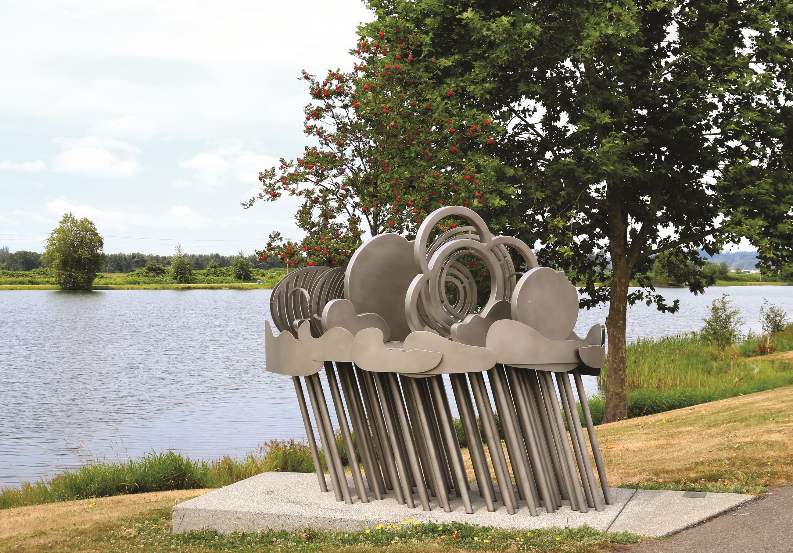 A photo of the Storm Systems Sculpture on a sunny day overlooking Lake Tye in Monroe.